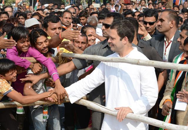 Rahul Gandhi shakes hands with supporters during a political rally at Chilloda village, some 40 km from Ahmedabad. (AFP Photo) Rahul Gandhi shakes hands with supporters during a political rally at Chilloda village, some 40 km from Ahmedabad. (AFP Photo)