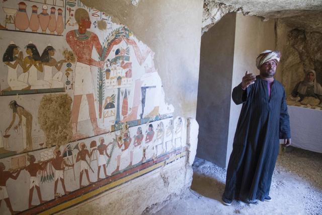 An Egyptian guard stands next to a funeral mural inside a newly discovered tomb on Luxor's West Bank known as "KAMPP 161" during an announcement for the Egyptian Ministry of antiquities about new discoveries in Luxor, Egypt, Saturday, Dec. 9, 2017. (AP) An Egyptian guard stands next to a funeral mural inside a newly discovered tomb on Luxor's West Bank known as "KAMPP 161" during an announcement for the Egyptian Ministry of antiquities about new discoveries in Luxor, Egypt, Saturday, Dec. 9, 2017. (AP)