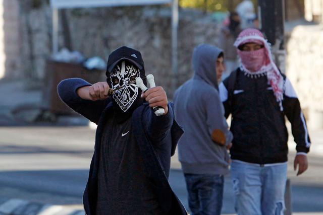 A Palestinian protestor throws stones towards Israeli forces during clashes near an Israeli checkpoint in the West Bank town of Bethlehem on December 9, 2017, following the US president's decision to recognize the city of Jerusalem as the capital of Israel. (AFP Photo) A Palestinian protestor throws stones towards Israeli forces during clashes near an Israeli checkpoint in the West Bank town of Bethlehem on December 9, 2017, following the US president's decision to recognize the city of Jerusalem as the capital of Israel. (AFP Photo)