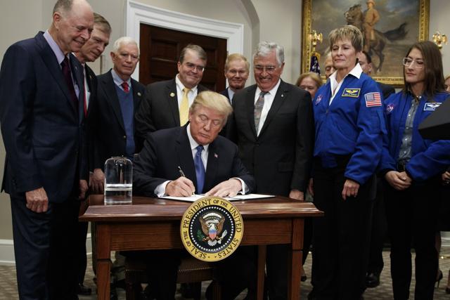 President Donald Trump signs a policy directive to send American astronauts back to the moon, and eventually Mars, in the Roosevelt Room of the White House, on Monday. (AP) President Donald Trump signs a policy directive to send American astronauts back to the moon, and eventually Mars, in the Roosevelt Room of the White House, on Monday. (AP)