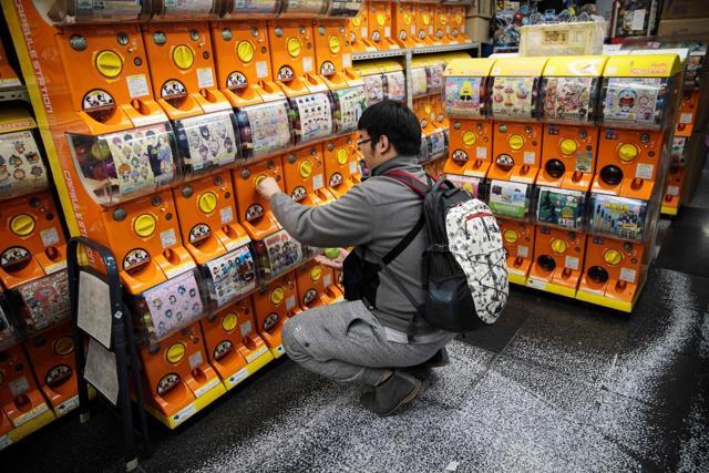 A man turns the crank of a vending machine during his hunt for capsule toys at a store in Tokyo’s Akihabara district. (AFP) A man turns the crank of a vending machine during his hunt for capsule toys at a store in Tokyo’s Akihabara district. (AFP)