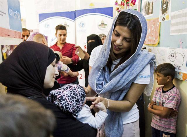 Priyanka Chopra, a UNICEF Goodwill Ambassador, with a Syrian woman and her baby at UNICEF's Makani Centre in Amman, Jordan in September 2017. (AP)