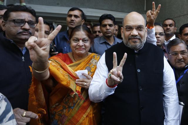 Bharatiya Janata Party president Amit Shah and his wife Sonal Shah display victory sign after casting their votes for the second phase of Gujarat state assembly elections in Ahmadabad on Thursday. (AP Photo) Bharatiya Janata Party president Amit Shah and his wife Sonal Shah display victory sign after casting their votes for the second phase of Gujarat state assembly elections in Ahmadabad on Thursday. (AP Photo)