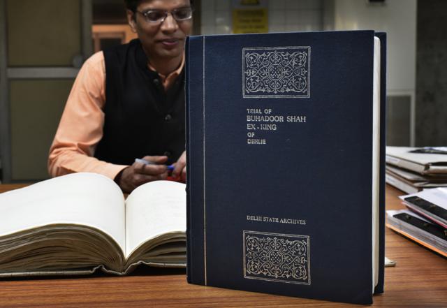 An official with a copy of the trial of Bahadur Shah Zafar. (Vipin Kumar/HT PHOTO) An official with a copy of the trial of Bahadur Shah Zafar. (Vipin Kumar/HT PHOTO)