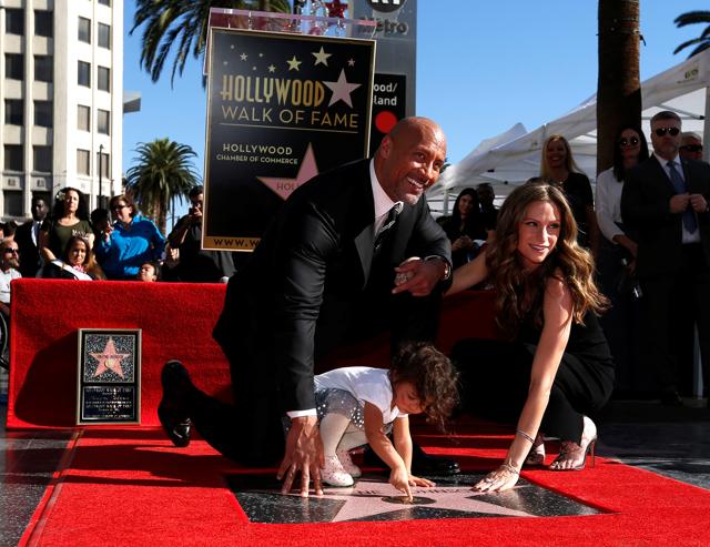 Actor Dwayne Johnson poses on his star with Lauren Hashian and their daughter Jasmine Lia after it was unveiled on the Hollywood Walk of Fame in Los Angeles. (REUTERS) Actor Dwayne Johnson poses on his star with Lauren Hashian and their daughter Jasmine Lia after it was unveiled on the Hollywood Walk of Fame in Los Angeles. (REUTERS)