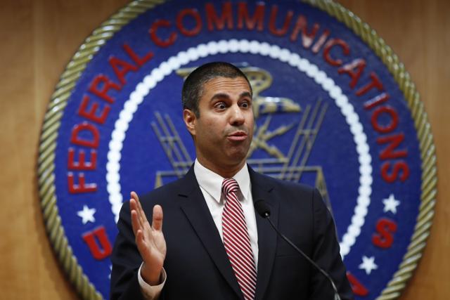 After a meeting voting to end net neutrality, Federal Communications Commission (FCC) chairman Ajit Pai answers a question from a reporter in Washington on Thursday. (AP) After a meeting voting to end net neutrality, Federal Communications Commission (FCC) chairman Ajit Pai answers a question from a reporter in Washington on Thursday. (AP)