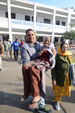 Sandeep carries his grandmother Ishri Devi, who celebrated her 105th birthday on December 15, after she cast her vote in Jalandhar on Sunday. (Pardeep Pandit/HT)
