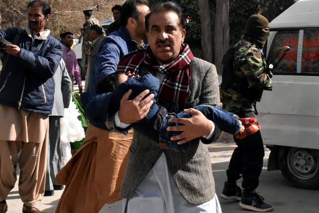 A man carries a boy as he walks out after gunmen attacked the Bethel Memorial Methodist Church in Quetta, Pakistan on December 17, 2017. (Reuters) A man carries a boy as he walks out after gunmen attacked the Bethel Memorial Methodist Church in Quetta, Pakistan on December 17, 2017. (Reuters)
