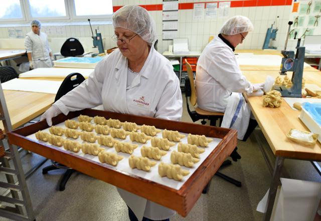Employees are busy preparing pigs made of fresh marzipan at the headquarters of the traditional confectionary maker JG Niederegger GmbH in Luebeck. (AFP) Employees are busy preparing pigs made of fresh marzipan at the headquarters of the traditional confectionary maker JG Niederegger GmbH in Luebeck. (AFP)