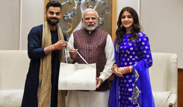 Prime Minister Narendra Modi with newly-wed couple of cricketer Virat Kohli and Anushka Sharma in New Delhi on Wednesday. (PTI) Prime Minister Narendra Modi with newly-wed couple of cricketer Virat Kohli and Anushka Sharma in New Delhi on Wednesday. (PTI)