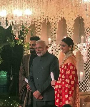 Prime Minister Narendra Modi with Indian cricket team captain, Virat Kohli and his wife actress Anushka Sharma during their wedding reception, in New Delhi on Thursday. (PTI) Prime Minister Narendra Modi with Indian cricket team captain, Virat Kohli and his wife actress Anushka Sharma during their wedding reception, in New Delhi on Thursday. (PTI)