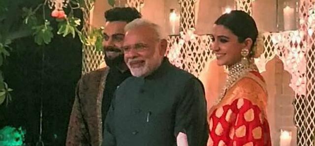 Virat Kohli and Anushka Sharma with Prime Minister Narendra Modi at the Delhi wedding reception. Virat Kohli and Anushka Sharma with Prime Minister Narendra Modi at the Delhi wedding reception.