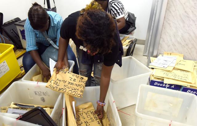 Electoral officers count votes at Monrovia Stadium on December 27, 2017 following the second round of the presidential election. (AFP) Electoral officers count votes at Monrovia Stadium on December 27, 2017 following the second round of the presidential election. (AFP)