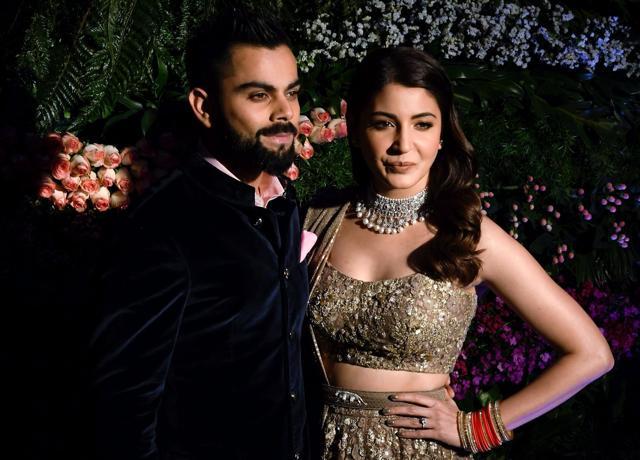 Indian cricket team captain, Virat Kohli and his wife actor Anushka Sharma pose for photographers during their wedding reception, Mumbai on Tuesday. (PTI) Indian cricket team captain, Virat Kohli and his wife actor Anushka Sharma pose for photographers during their wedding reception, Mumbai on Tuesday. (PTI)