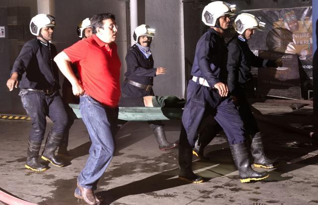 Disaster management officials rescue another victim from the spot. By 2.45am, the fire brigade had managed to bring the fire under control. (ANSHUMAN POYREKAR/HT PHOTO) Disaster management officials rescue another victim from the spot. By 2.45am, the fire brigade had managed to bring the fire under control. (ANSHUMAN POYREKAR/HT PHOTO)