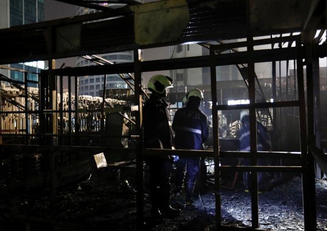 Firemen inspect the debris after a fire at a restaurant in Mumbai on December 29. (Reuters) Firemen inspect the debris after a fire at a restaurant in Mumbai on December 29. (Reuters)