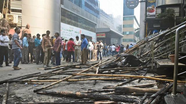 Onlookers gather outside the building that caught fire in Mumbai on Friday. (PTI) Onlookers gather outside the building that caught fire in Mumbai on Friday. (PTI)