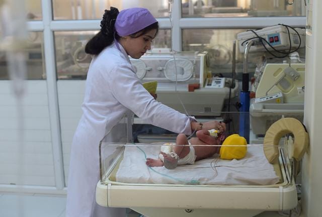 This picture taken on December 26, 2017 shows an Afghan paediatrician checking on a newborn baby at a maternity ward in the Malalai Maternity Hospital in Kabul. (AFP) This picture taken on December 26, 2017 shows an Afghan paediatrician checking on a newborn baby at a maternity ward in the Malalai Maternity Hospital in Kabul. (AFP)