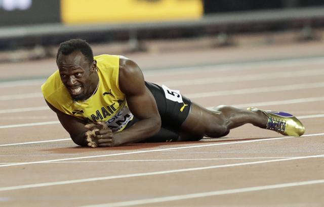 Usain Bolt lies on the track after he injured himself in the 4x100 meter relay final at the World Athletics Championships in London. (AP) Usain Bolt lies on the track after he injured himself in the 4x100 meter relay final at the World Athletics Championships in London. (AP)