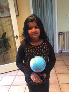 Six-year-old Ashmita Deswal with the globe purchased by her parents for her. (Courtesy Sandeep Deswal)