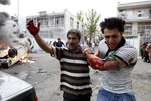 In this June 15, 2009 file photo, a protester allegedly injured by gunfire from pro-government militia is helped by another protester near a rally in Tehran (AP) In this June 15, 2009 file photo, a protester allegedly injured by gunfire from pro-government militia is helped by another protester near a rally in Tehran (AP)