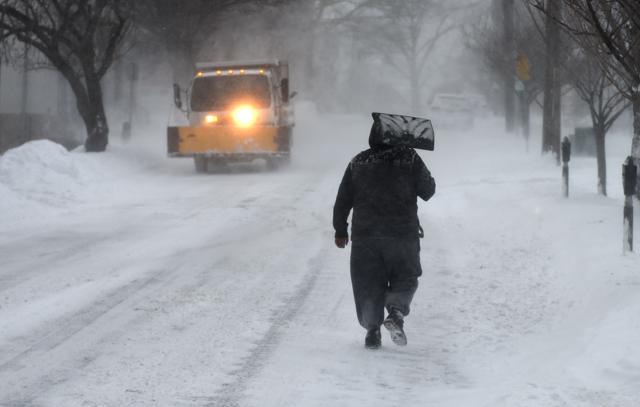 A man carries a shovel in Greenwich, Connecticut, on Thursday. (AFP) A man carries a shovel in Greenwich, Connecticut, on Thursday. (AFP)
