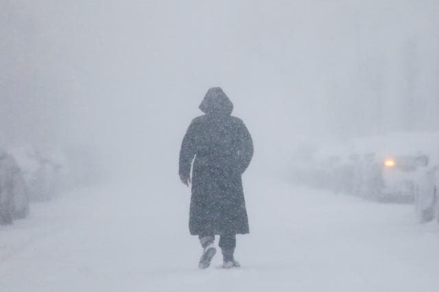 A woman walks down the street during a blizzard in Long Beach, New York. (Reuters) A woman walks down the street during a blizzard in Long Beach, New York. (Reuters)