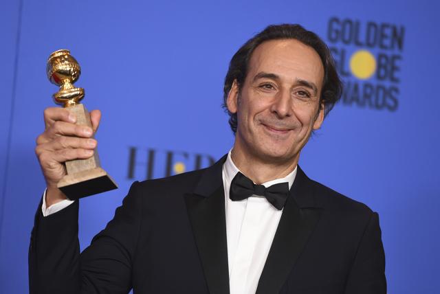 Alexandre Desplat poses in the press room with the award for best original score. (Jordan Strauss/Invision/AP)