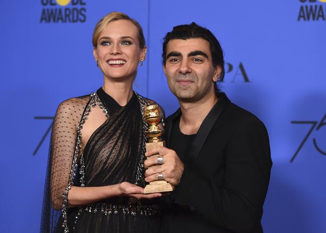 Diane Kruger, left, and Fatih Akin poses in the press room with the award for best motion picture - foreign language for In The Fade. (Jordan Strauss/Invision/AP)