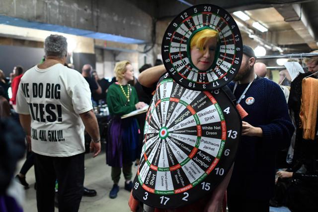 A model gets prepared backstage with an outfit resembling dart boards ahead of the MAN collection catwalk show. (AFP) A model gets prepared backstage with an outfit resembling dart boards ahead of the MAN collection catwalk show. (AFP)