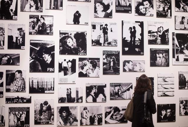A woman walking past photographs of final pages of photo novels during a press preview of the exhibition. (AFP/BERTRAND LANGLOIS) A woman walking past photographs of final pages of photo novels during a press preview of the exhibition. (AFP/BERTRAND LANGLOIS)