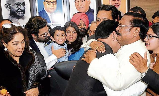 Former Chandigarh MP Satya Pal Jain (in white) shares an emotional moment with newly elected mayor Davesh Moudgil as Chandigarh MP Kirron Kher and other BJP workers look on. (Keshav Singh/HT)