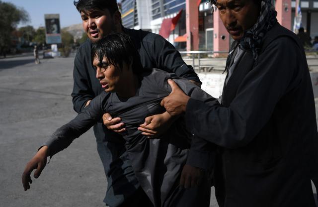 File photo taken on August 25, 2017 shows Afghan Shia men carrying a wounded friend near the site of a suicide attack claimed by the Islamic State group that targeted a Shia mosque in Kabul. (AFP) File photo taken on August 25, 2017 shows Afghan Shia men carrying a wounded friend near the site of a suicide attack claimed by the Islamic State group that targeted a Shia mosque in Kabul. (AFP)