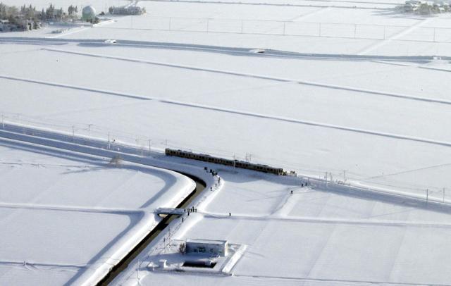 Train stranded in Sanjo, Niigata prefecture, north of Tokyo on Friday. (AP) Train stranded in Sanjo, Niigata prefecture, north of Tokyo on Friday. (AP)