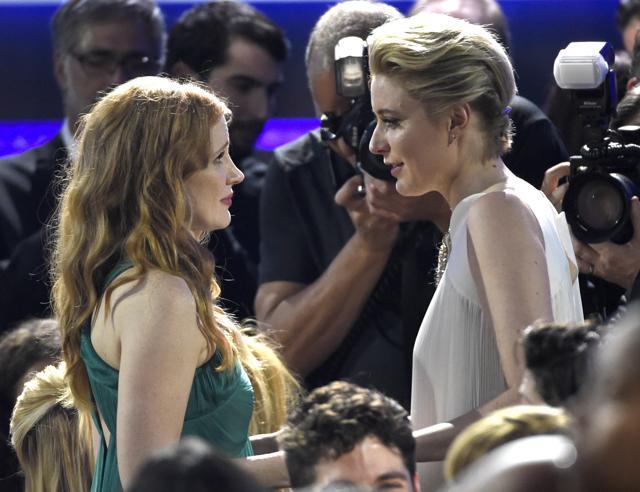 Jessica Chastain, left, and Greta Gerwig speak in the audience. (Chris Pizzello/Invision/AP)