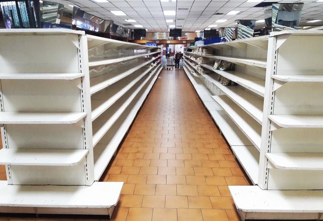 View of almost empty supermarket shelves in Caracas on January 11, 2018. (AFP Photo)