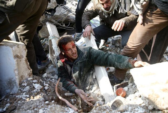 A man gets stuck under debris at a damaged site after an airstrike in the Saqba area. (Reuters Photo) A man gets stuck under debris at a damaged site after an airstrike in the Saqba area. (Reuters Photo)