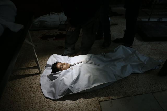 The body of a young victim lies on the ground at a makeshift hospital following reported artillery shelling in Hammuriyeh in the rebel-held Eastern Ghouta area. (AFP Photo) The body of a young victim lies on the ground at a makeshift hospital following reported artillery shelling in Hammuriyeh in the rebel-held Eastern Ghouta area. (AFP Photo)