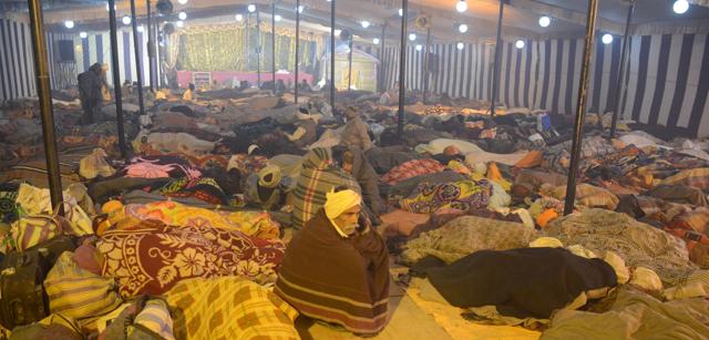 Pilgrims sleeping in the giant pandal of Mahant Nityagopal Das. (Anil Kumar Maurya/HT)