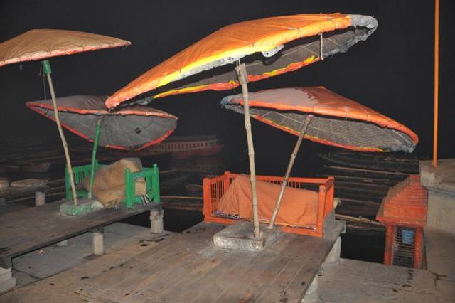 Parasols and a slumbering sadhu at Ganga ghat. (Rajesh Kumar/HT Photo)