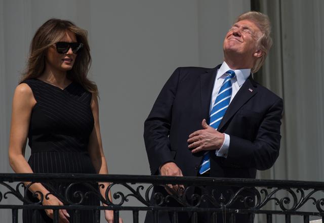Melania with her husband Donald Trump looking up at the partial solar eclipse from the balcony of the White House in Washington, DC. (AFP) Melania with her husband Donald Trump looking up at the partial solar eclipse from the balcony of the White House in Washington, DC. (AFP)