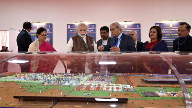 Prime Minister Narendra Modi takes a tour of an exhibition on Barmer Refinery, in Barmer on Tuesday. Union Petroleum Minister Dharmendra Pradhan and Rajasthan Chief Minister Vasundhara Raje are also seen. (PTI) Prime Minister Narendra Modi takes a tour of an exhibition on Barmer Refinery, in Barmer on Tuesday. Union Petroleum Minister Dharmendra Pradhan and Rajasthan Chief Minister Vasundhara Raje are also seen. (PTI)