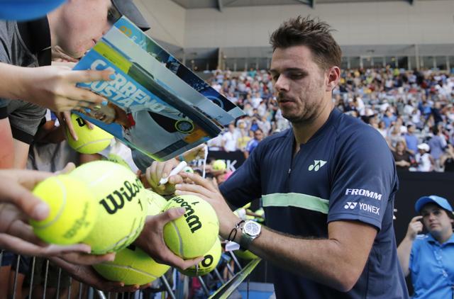 Stan Wawrinka of Switzerland signs autographs after his win against Ricardas Berankis of Lithuania. (REUTERS) Stan Wawrinka of Switzerland signs autographs after his win against Ricardas Berankis of Lithuania. (REUTERS)