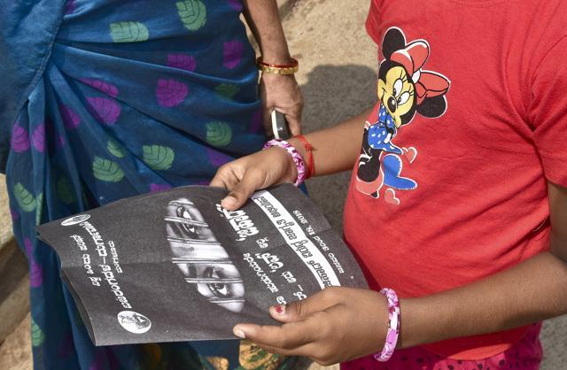 A girl reads the leaflet distributed by Bajrang Dal workers at Kadri Manjunatha Temple in Mangaluru on January 6. (Arijit Sen/HT Photo) A girl reads the leaflet distributed by Bajrang Dal workers at Kadri Manjunatha Temple in Mangaluru on January 6. (Arijit Sen/HT Photo)
