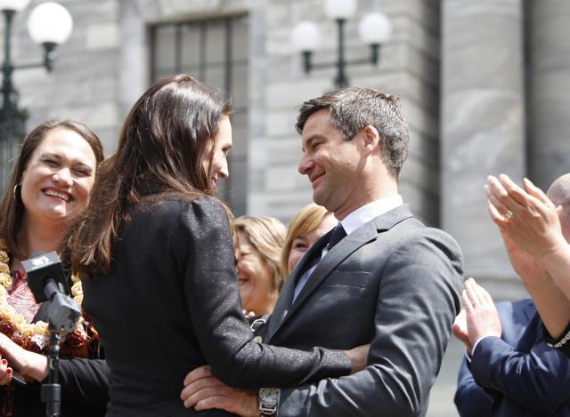 New Zealand Prime Minister Jacinda Ardern embraces her partner Clarke Gayford after speaking to well-wishers in front of the parliament in Wellington. (AP File Photo) New Zealand Prime Minister Jacinda Ardern embraces her partner Clarke Gayford after speaking to well-wishers in front of the parliament in Wellington. (AP File Photo)