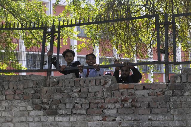 Students of Government Model Senior Secondary School, Sector 27, scaling its boundary wall on Friday. (Karun Sharma/HT)