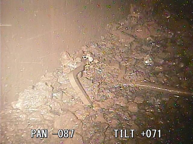 This photo taken and released on January 19, 2018 by the International Research Institute for Nuclear Decommissioning shows broken metal parts and debris that could be melted fuel inside the second reactor of Fukushima Daiichi nuclear power plant in Okuma, Fukushima prefecture. Tokyo Electric Power Co (TEPCO), operator of Fukushima's crippled nuclear power plant, inserted a special camera into the one of the plant's three melted down reactors as part of its efforts to dismantle the disaster-hit facility in northeastern Japan. (AFP) This photo taken and released on January 19, 2018 by the International Research Institute for Nuclear Decommissioning shows broken metal parts and debris that could be melted fuel inside the second reactor of Fukushima Daiichi nuclear power plant in Okuma, Fukushima prefecture. Tokyo Electric Power Co (TEPCO), operator of Fukushima's crippled nuclear power plant, inserted a special camera into the one of the plant's three melted down reactors as part of its efforts to dismantle the disaster-hit facility in northeastern Japan. (AFP)