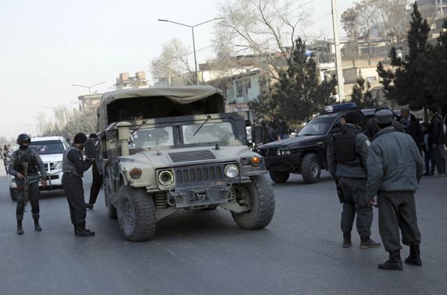 Policemen block the road to the Intercontinental Hotel during a deadly attack in Kabul, Afghanistan. (AP Photo) Policemen block the road to the Intercontinental Hotel during a deadly attack in Kabul, Afghanistan. (AP Photo)