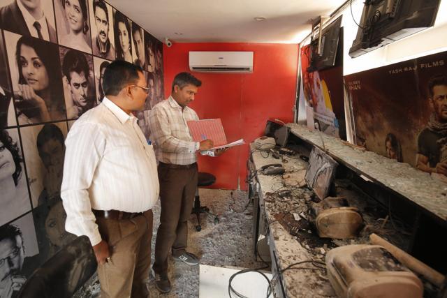 Ahmedabad : Forensic experts examine the ticket counter of the cinema hall after it was vandalised in protest against the release of the film Padmaavat in Ahmedabad on Sunday. (PTI) Ahmedabad : Forensic experts examine the ticket counter of the cinema hall after it was vandalised in protest against the release of the film Padmaavat in Ahmedabad on Sunday. (PTI)