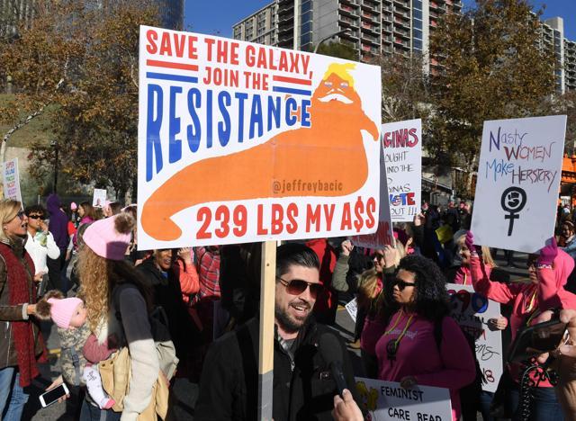 Protesters, part of a 500,000 strong crowd, during the Women's Rally on the one-year anniversary of the first Women's March, when millions marched around the world to protest US President Donald Trump's inauguration, in Los Angeles, California on January 20, 2018. / (AFP)